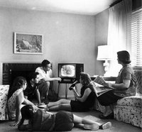 An American family watching television in the 1950s.