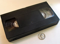 Top view VHS cassette with U.S. Quarter for scale