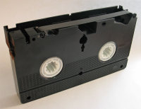 Bottom view of VHS cassette with magnetic tape exposed